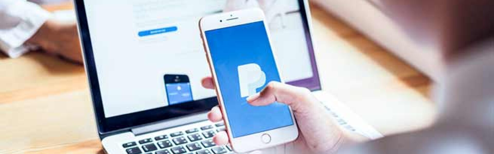 PayPal Leitfaden für die Buchhaltung: PayPal Zahlungen richtig verbuchen RTS Smartphone mit PayPal Logo und Laptop im Hintergrund